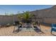 Charming patio is arranged with stylish seating, accented by decorative lighting, creating a welcoming outdoor living space at 2424 S 235Th Dr, Buckeye, AZ 85326