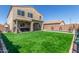 Spacious backyard showcasing artificial turf, a private pool, and covered patio at 2765 E Gillcrest Rd, Gilbert, AZ 85298