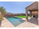 Relaxing backyard featuring a private pool, covered patio, and artificial turf at 2765 E Gillcrest Rd, Gilbert, AZ 85298