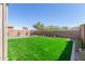 Expansive backyard featuring lush artificial grass, a pool, and well-maintained landscaping at 2765 E Gillcrest Rd, Gilbert, AZ 85298