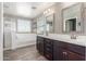 Bathroom with a double vanity with dark wood cabinets and a separate shower and tub at 2765 E Gillcrest Rd, Gilbert, AZ 85298