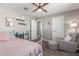 This bedroom boasts a ceiling fan, chair with footstool and cozy décor at 2765 E Gillcrest Rd, Gilbert, AZ 85298