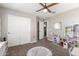 Neutral ' bedroom with ceiling fan, plush carpet, and organized toys and storage at 2765 E Gillcrest Rd, Gilbert, AZ 85298