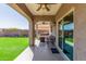 Inviting covered patio with BBQ area, seating, and a view of the well-maintained backyard at 2765 E Gillcrest Rd, Gilbert, AZ 85298