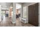 Bright entryway with wood-look tile flooring, a decorative wood wall, and views into the dining room at 2765 E Gillcrest Rd, Gilbert, AZ 85298
