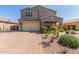 Inviting two-story home with a desert landscape, a brick driveway and a two car garage at 2765 E Gillcrest Rd, Gilbert, AZ 85298