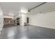 Spacious garage with epoxy flooring, built-in storage, and ample room for vehicles at 2765 E Gillcrest Rd, Gilbert, AZ 85298