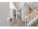 Hallway with wood-look tile floors leading to an open concept floorplan, including a staircase at 2765 E Gillcrest Rd, Gilbert, AZ 85298
