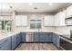 Stylish kitchen with a peninsula, blue and white cabinets, and updated stainless steel appliances at 2765 E Gillcrest Rd, Gilbert, AZ 85298