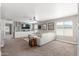 Open living room with carpet, ceiling fan, tv and entertainment area, and multiple windows for natural light at 2765 E Gillcrest Rd, Gilbert, AZ 85298