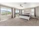 Spacious main bedroom with large windows offering mountain views, neutral carpet, and ceiling fan at 2765 E Gillcrest Rd, Gilbert, AZ 85298