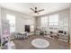 Bright playroom features carpet, ceiling fan, and multiple windows for natural light at 2765 E Gillcrest Rd, Gilbert, AZ 85298