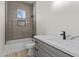 Modern bathroom featuring neutral walls, a shower over tub, tile surround, and white vanity with marble countertops at 28917 N 201St Ave, Wittmann, AZ 85361