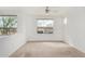 Bright bedroom with carpet and large windows offering ample natural light and neighborhood views at 29606 N Tatum Blvd # 121, Cave Creek, AZ 85331