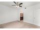 Bedroom features carpet, ceiling fan, and an arched entrance to the ensuite bathroom with a vanity at 29606 N Tatum Blvd # 121, Cave Creek, AZ 85331