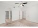 Bedroom features carpet, ceiling fan, and easy access to ensuite bath with dual closets and walk-in shower at 29606 N Tatum Blvd # 121, Cave Creek, AZ 85331