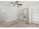Well-lit bedroom featuring a ceiling fan, private balcony access, and convenient built-in shelving at 29606 N Tatum Blvd # 121, Cave Creek, AZ 85331