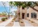 Neutral-toned building exterior featuring private entryways and desert landscaping for a modern feel at 29606 N Tatum Blvd # 121, Cave Creek, AZ 85331
