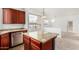 Open-concept kitchen with granite countertops, wood cabinets, and stainless steel appliances at 29606 N Tatum Blvd # 121, Cave Creek, AZ 85331