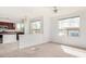 Open floor plan connecting the living room and kitchen with natural light from multiple windows at 29606 N Tatum Blvd # 121, Cave Creek, AZ 85331