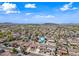 Overhead aerial shot showcases home in a sprawling community featuring mountain views and blue skies at 3144 W Maya Way, Phoenix, AZ 85083