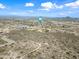 Desert landscape view with a neighborhood in the distance, shot from above at 3144 W Maya Way, Phoenix, AZ 85083