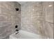 Modern bathroom featuring gray tiled shower with black fixtures, and a clean white tub at 3144 W Maya Way, Phoenix, AZ 85083