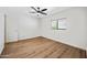 Bright, airy bedroom with wood floors, ceiling fan and a window at 3144 W Maya Way, Phoenix, AZ 85083