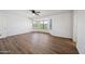 Bright bedroom with wood-look floors, white walls, and bay windows providing natural light and neighborhood views at 3144 W Maya Way, Phoenix, AZ 85083