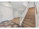 Inviting foyer featuring tile flooring, a staircase, and a view into the adjacent living spaces at 3144 W Maya Way, Phoenix, AZ 85083