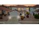 Two-story home with a two-car garage, tiled roof, and well-maintained landscaping at sunset at 3144 W Maya Way, Phoenix, AZ 85083