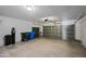 Spacious two car garage with concrete flooring, storage cabinets and a garage door at 3144 W Maya Way, Phoenix, AZ 85083