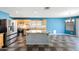 Bright kitchen boasts stainless steel appliances, wooden cabinets, a center island and mixed color tiled flooring at 3144 W Maya Way, Phoenix, AZ 85083