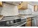 Modern kitchen features granite countertops, stainless steel appliances, and mosaic tile backsplash at 3144 W Maya Way, Phoenix, AZ 85083
