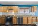 Bright kitchen features stainless steel appliances, wooden cabinets, a granite countertop, and tile backsplash at 3144 W Maya Way, Phoenix, AZ 85083