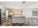 Well-appointed kitchen featuring stainless steel appliances, granite countertops, and a center island at 3144 W Maya Way, Phoenix, AZ 85083
