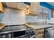 Stylish kitchen showcasing stainless appliances, granite counters, and mosaic tile backsplash at 3144 W Maya Way, Phoenix, AZ 85083