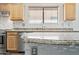 Kitchen with a granite-topped island, stainless steel appliances and mosaic backsplash at 3144 W Maya Way, Phoenix, AZ 85083