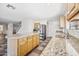 Bright kitchen featuring granite countertops, stainless steel appliances and a view into the adjacent living spaces at 3144 W Maya Way, Phoenix, AZ 85083
