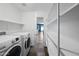 Spacious laundry area with shelving, modern appliances, and tile flooring at 3144 W Maya Way, Phoenix, AZ 85083