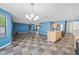 Open concept living room features mixed color tiled flooring, stainless steel appliances, and blue walls at 3144 W Maya Way, Phoenix, AZ 85083