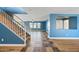 Open-concept living room and staircase with hardwood floors and blue walls at 3144 W Maya Way, Phoenix, AZ 85083