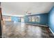 Open-concept living area featuring tile flooring, natural light, and access to the kitchen at 3144 W Maya Way, Phoenix, AZ 85083