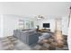 Open concept living room featuring a large gray sectional, flat screen tv, and natural lighting at 3144 W Maya Way, Phoenix, AZ 85083