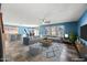 Spacious living room features a large sectional sofa, bar seating, and lots of natural light at 3144 W Maya Way, Phoenix, AZ 85083