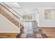 Spacious living room showcasing wood-look flooring, staircase, and natural light from multiple windows at 3144 W Maya Way, Phoenix, AZ 85083