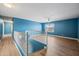 Spacious loft area with wood floors, bright blue walls, and a large window at 3144 W Maya Way, Phoenix, AZ 85083