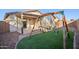 Backyard featuring a small swing set and covered patio at 325 W Angus Rd, San Tan Valley, AZ 85143