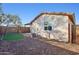 Wide view of the backyard, including a swing set and covered patio at 325 W Angus Rd, San Tan Valley, AZ 85143