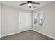 Bright bedroom with wood floors, closet, ceiling fan, and natural light at 325 W Angus Rd, San Tan Valley, AZ 85143